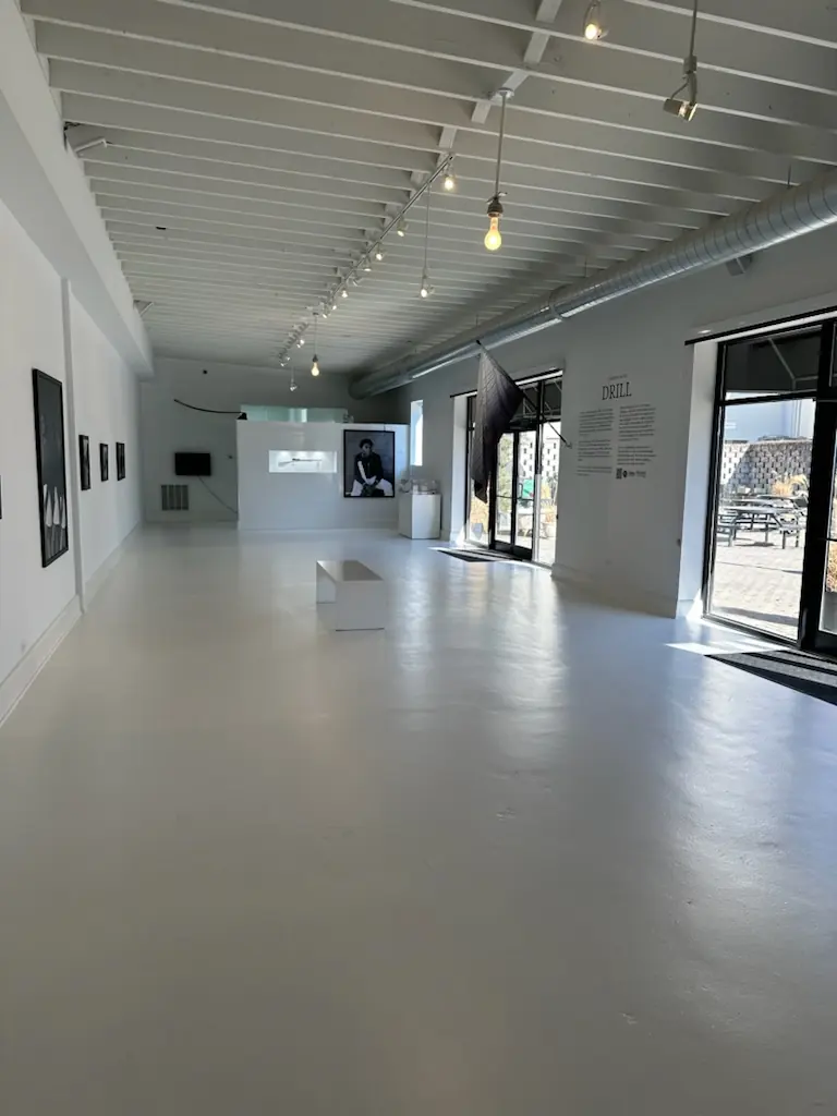 View down the length of the gallery toward the street windows.